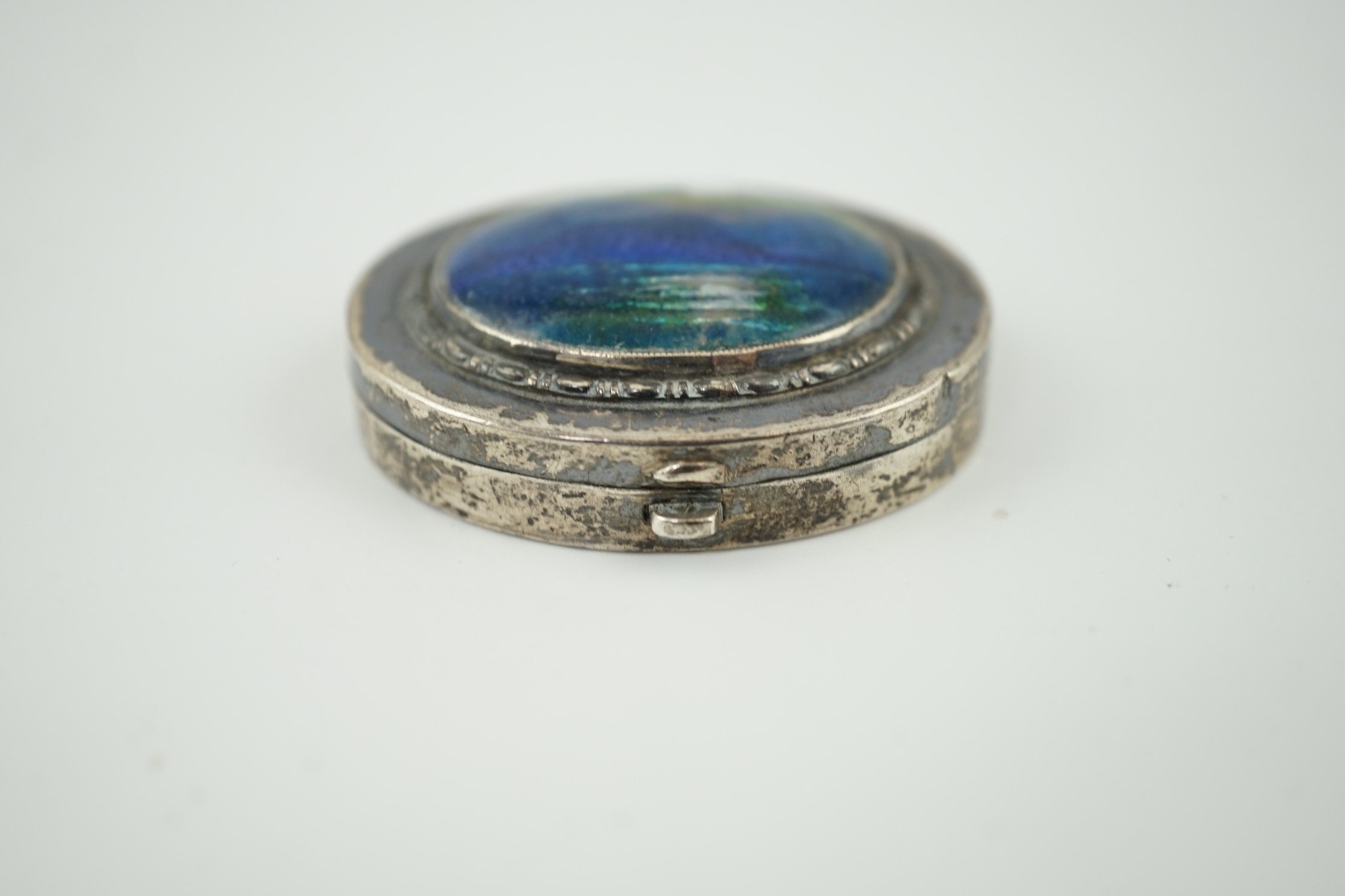 A George V Arts & Crafts Liberty & Co silver and enamel oval pill box, with hinged cover, Birmingham, 1929